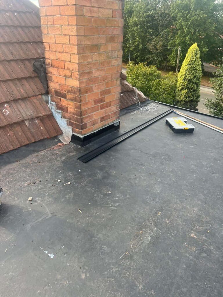 This is a photo of a flat roof which has just been repaired, there is also a chimney stack and some leadwork has also been dressed. Works carried out by New Ollerton Roofing Repairs